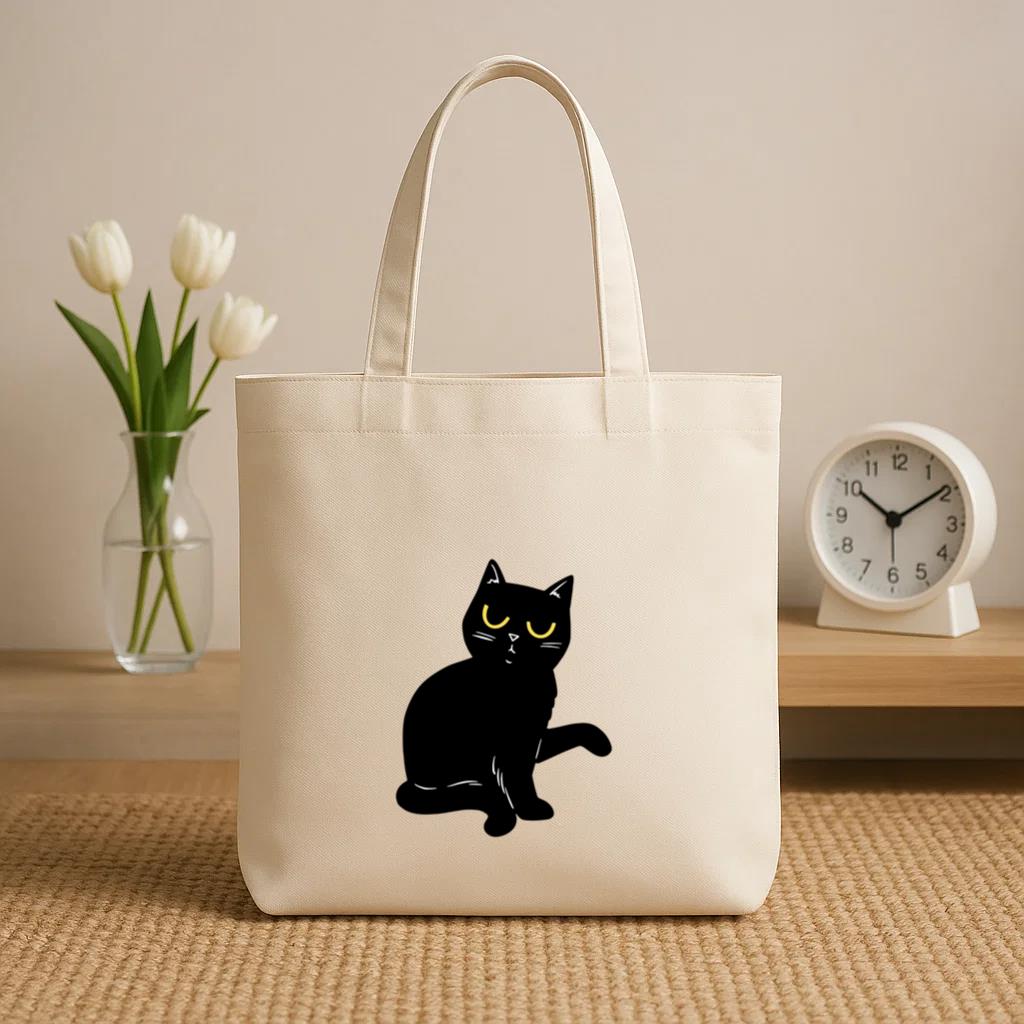 Black Cat With Yellow Eyes Sitting Canvas Tote Bag image 0