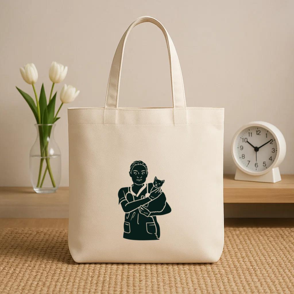Black And White Illustration Of A Nurse Holding A Cat Canvas Tote Bag image 1